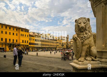 View of Santa Croce Square in the historic centre of Florence with a lion statue on the base of the Monument to Dante Alighieri, Tuscany, Italy