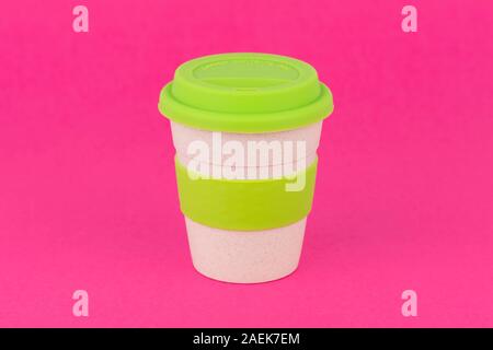A reusable coffee cup shot on a pink background. Stock Photo
