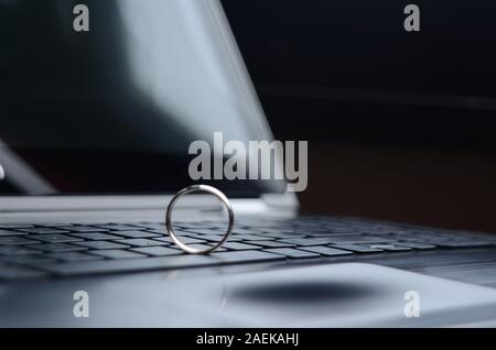 STARGATE: A gold ring appears on the keyboard of a laptop computer. Stock Photo