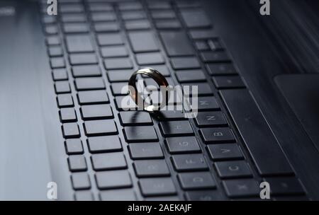 STARGATE: A gold ring appears on the keyboard of a laptop computer. Stock Photo