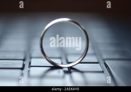 STARGATE: A gold ring appears on the keyboard of a laptop computer. Stock Photo