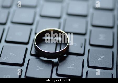 STARGATE: A gold ring appears on the keyboard of a laptop computer. Stock Photo