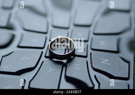 STARGATE: A gold ring appears on the keyboard of a laptop computer. Stock Photo