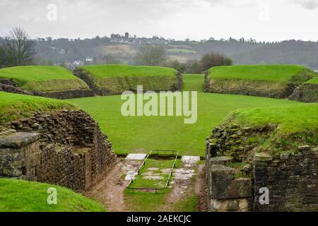 Grass covered remains of the ancient Roman amphitheatre at Caerleon Roman Fortress, Isca, near Newport, Gwent, south Wales Stock Photo