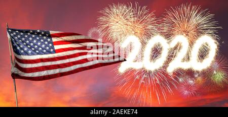 Happy New Year 2020 with fireworks setting off in the sunset background and flying USA Flag. Stock Photo