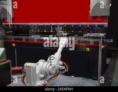 Robotic loading metal sheet to CNC Synchronize Hydraulic press, Industrial machining Stock Photo