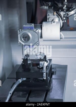 Robotic loading workpiece to compact CNC lathe sliding headstock Stock Photo