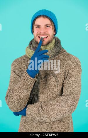 guy feel warm and comfortable. male knitwear fashion. men knitted cloth and accessory. male blue background. poor homeless man. funny man feeling cold in winter. no flu. winter weather forecast. Stock Photo