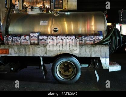 New York, NY USA. Aug 2017. Cans and truck with used soybean cooking oil from Asian restaurants in Manhattan to be recycled. Stock Photo