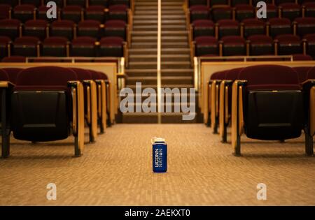 Storrs, CT USA. Oct 2019. Lost water bottle sitting on empty university lecture hall floor. Stock Photo