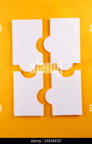 Parts of paper puzzles. Business concept, template, layout, infographics. Puzzles from paper on a bright orange background. Stock Photo