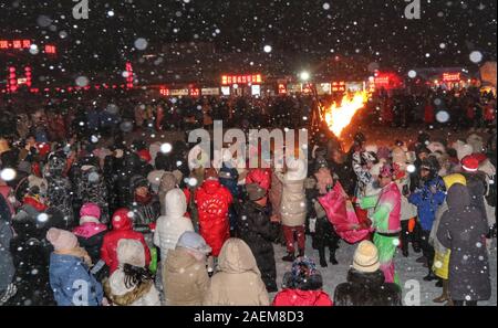 Peope dance at the Snow Carnival at the China Snow Town in Mudanjiang city, north-east China's Heilongjiang province, 27 November 2019.   To attract m Stock Photo