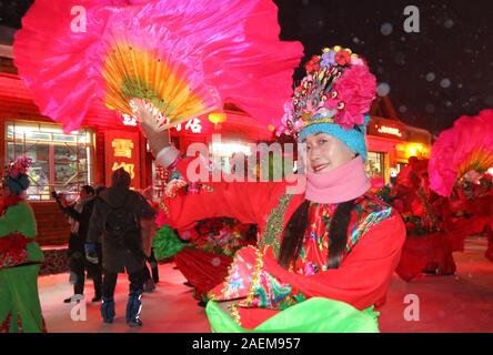 Peope dance at the Snow Carnival at the China Snow Town in Mudanjiang city, north-east China's Heilongjiang province, 27 November 2019.   To attract m Stock Photo