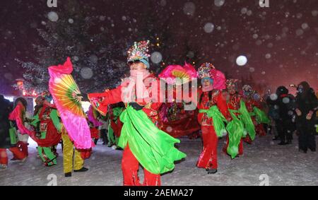 Peope dance at the Snow Carnival at the China Snow Town in Mudanjiang city, north-east China's Heilongjiang province, 27 November 2019.   To attract m Stock Photo