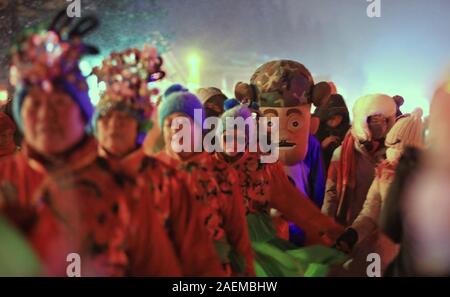 Peope dance at the Snow Carnival at the China Snow Town in Mudanjiang city, north-east China's Heilongjiang province, 27 November 2019.   To attract m Stock Photo