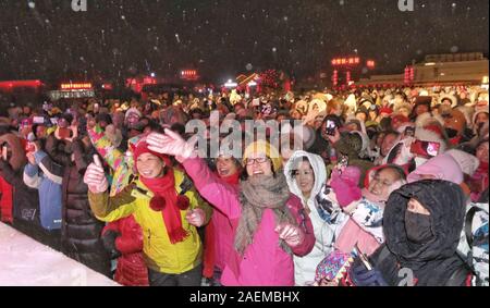 Peope dance at the Snow Carnival at the China Snow Town in Mudanjiang city, north-east China's Heilongjiang province, 27 November 2019.   To attract m Stock Photo