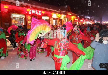 Peope dance at the Snow Carnival at the China Snow Town in Mudanjiang city, north-east China's Heilongjiang province, 27 November 2019.   To attract m Stock Photo