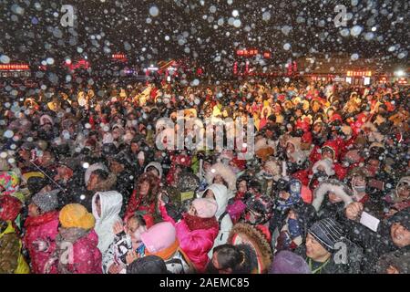 Peope dance at the Snow Carnival at the China Snow Town in Mudanjiang city, north-east China's Heilongjiang province, 27 November 2019.   To attract m Stock Photo