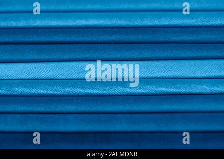 Textile samples for curtains. Blue tone curtain samples hanging. Stock Photo