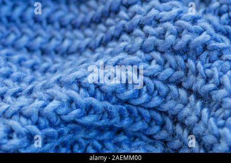 Blue knitted fabric closeup. Knitted wool background. Handmade. Close up. Stock Photo