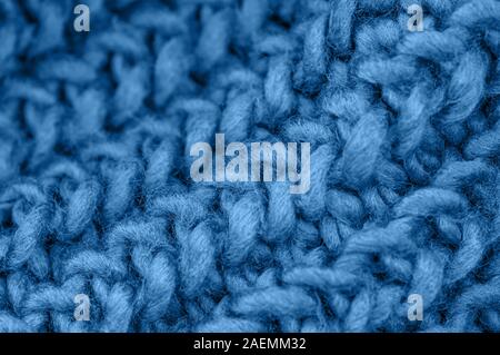 Blue knitted fabric closeup. Knitted wool background. Handmade. Close up. Stock Photo