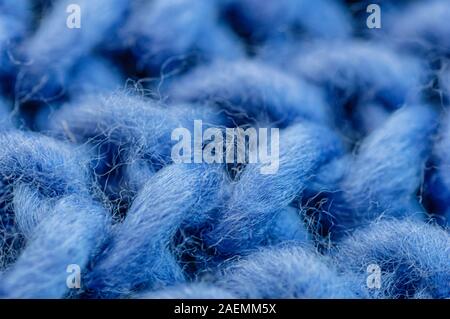 Blue knitted fabric closeup. Knitted wool background. Handmade. Macro. Stock Photo