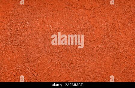 Red abstract texture toned in the trendy color. Decorative plaster. Close-up. Stock Photo