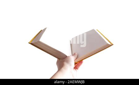 Female hand holding opened book on white background. Book in yellow hard book cover with blank pages. Education concept. Stock Photo