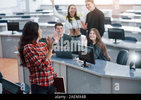 Nice to see you. Group of young people in casual clothes working in the modern office Stock Photo