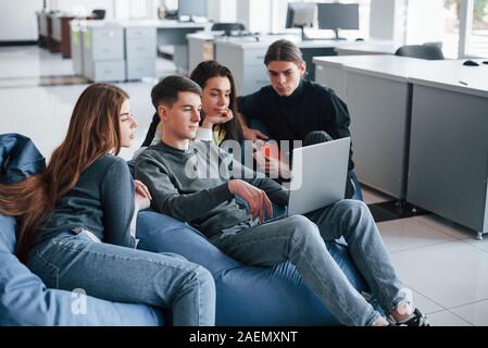 Process of work. Group of young people in casual clothes in the modern office Stock Photo