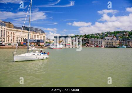 Sailing boat leaving Trouville bay (near Deauville) in Normandy, France. Stock Photo