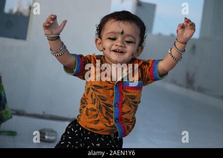 Indian baby boy of age 1 Year old in a playground.Cute happy baby face with black hair.Closeup of Very nice smile from Asian kid Stock Photo