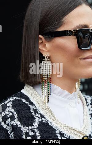 MILAN, ITALY - SEPTEMBER 22, 2019: Woman with Chanel earrings with colorful  gems and Louis Vuitton sunglasess before Gucci fashion show, Milan Fashion  Stock Photo - Alamy