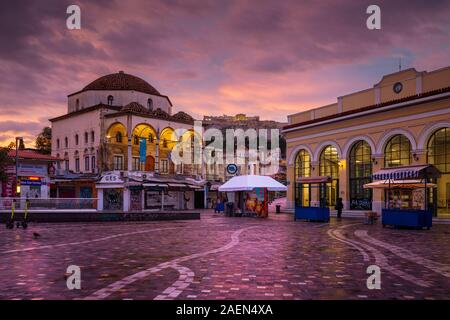 Athens, Greece - November 29, 2019: Early morning view of Acropolis, old mosque and metro station in Monastiraki square. Stock Photo