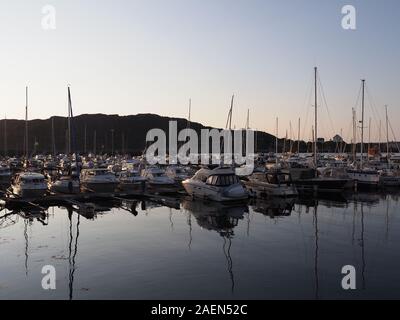 Dark view of boats and yachts in european Bodo city at Salten region in Norway at sun set Stock Photo