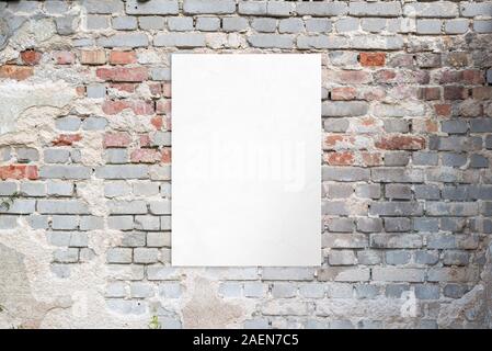 Poster mockup on an old brick street building wall. Clean, isolated paper for advertising presentation Stock Photo