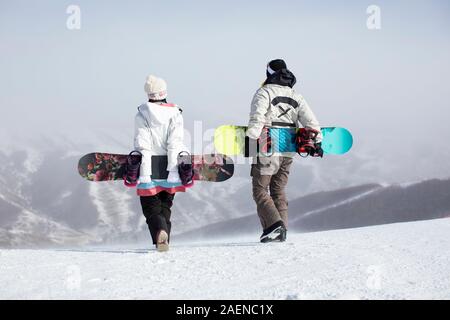 Young couple walking in ski resort Stock Photo
