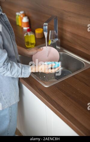 Young Asian girl holding a clean plate Stock Photo