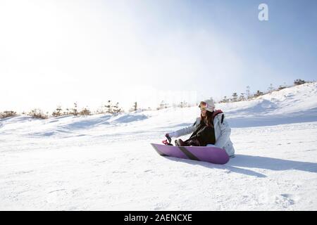 Happy young woman skiing in ski resort Stock Photo