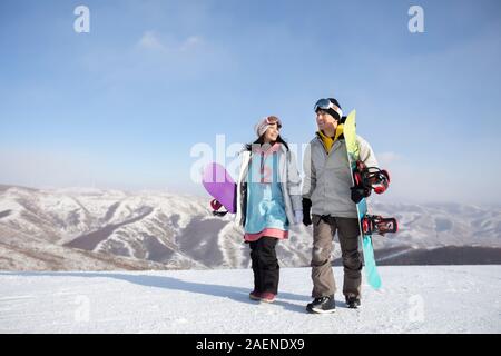 Young couple walking in ski resort Stock Photo