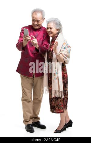 Happy senior couple using smartphone Stock Photo