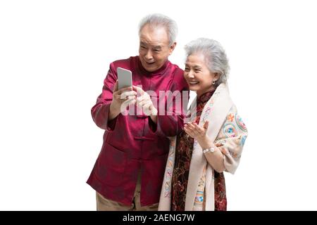 Happy senior couple using smartphone Stock Photo