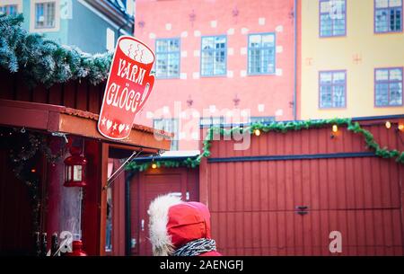 Person in winter clothes buyimg hot mulled wine, Christmas Market, Stortorget, Gamla Stan (Stockholm's old town), Stockholm, Sweden, Scandinavia Stock Photo