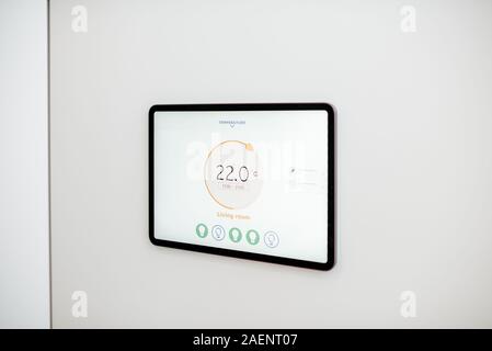 Digital touch screen panel for smart home managing with launched heating control application installed on the wall Stock Photo