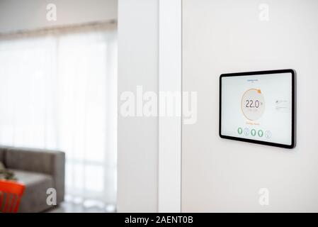 Digital touch screen panel for smart home managing with launched heating control application installed on the wall Stock Photo