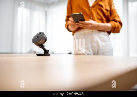 Close-up on wireless ip camera at the table at home. Concept of managing security devices remotely from a smart phone Stock Photo