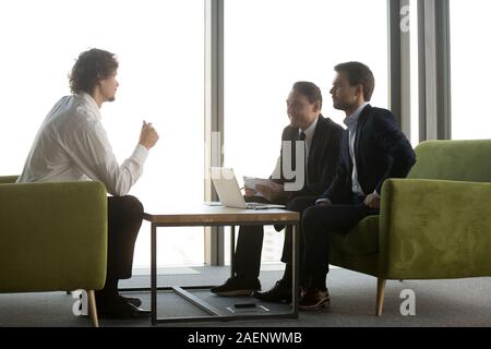 Candidate answering smiling hr managers questions in job interview Stock Photo