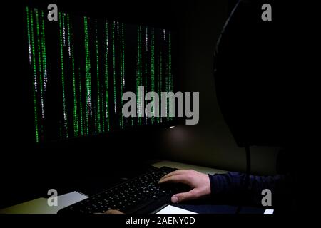 Hacker working on pc privacy data decript, cyber web securit,matrix code running Stock Photo