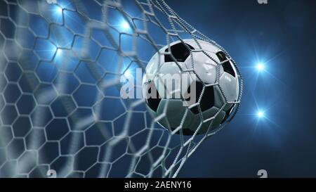 Soccer ball flew into the goal. Soccer ball bends the net, against the background of flashes of light. Soccer ball in goal net on blue background. A Stock Photo