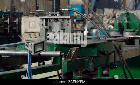 Automated machine line for cutting metal profiles in manufacturing process at industrial plant or factory. Concept for metalwork production. Stock Photo